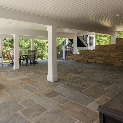 covered patio, white columns, and new retaining wall