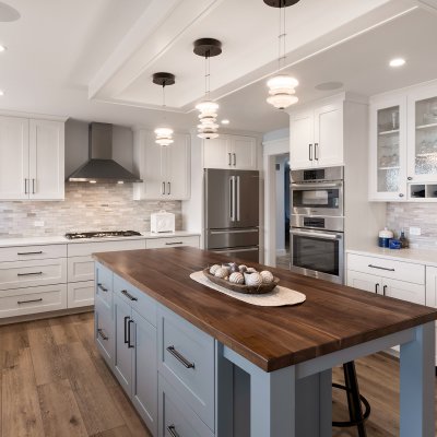 kitchen with white cabinets and large blue island