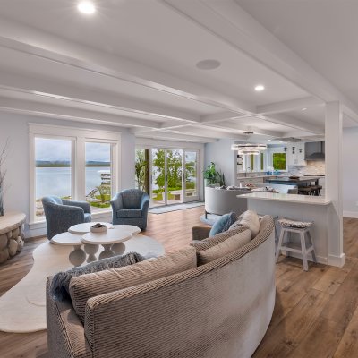 view across living room into kitchen with lake views outside